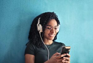 woman wearing headphones listening to her phone