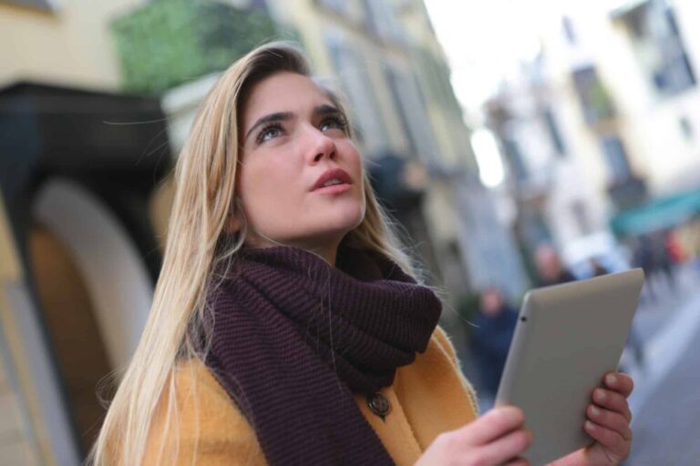 woman looking up from her tablet