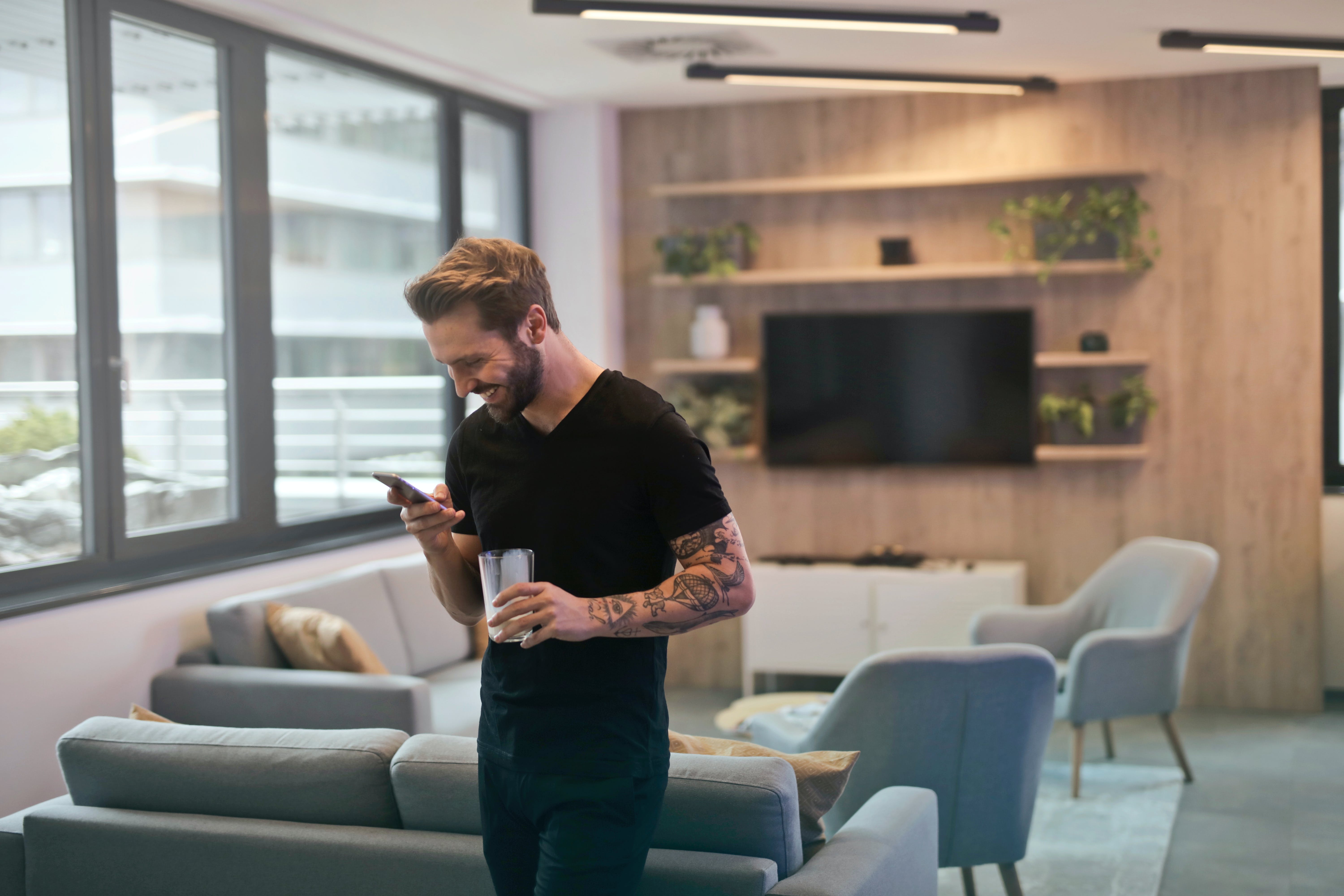 A man reads a text message on his smartphone