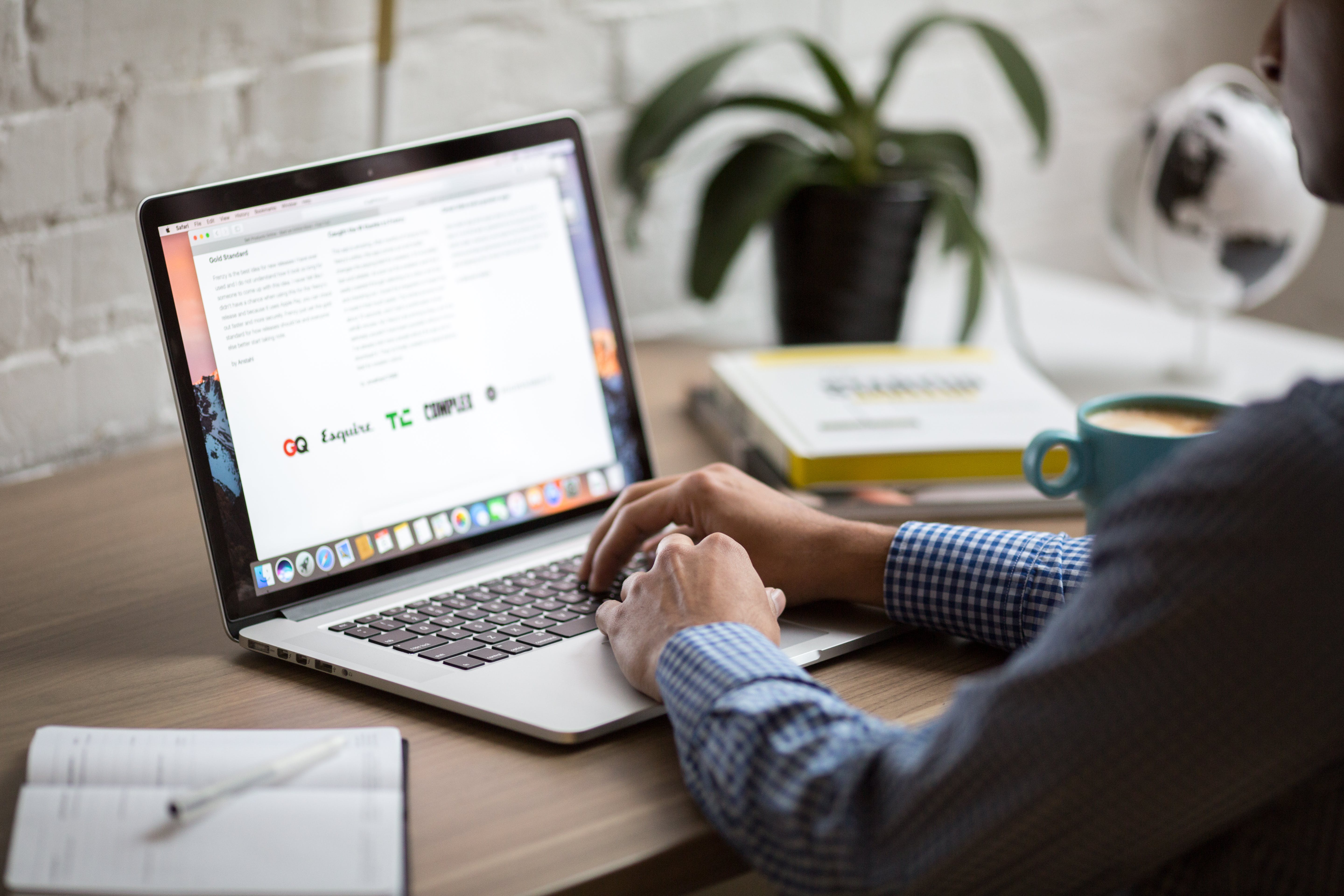 A person composes an email on their laptop