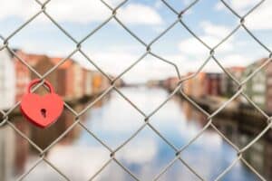 heart lock on a fence overlooking a river