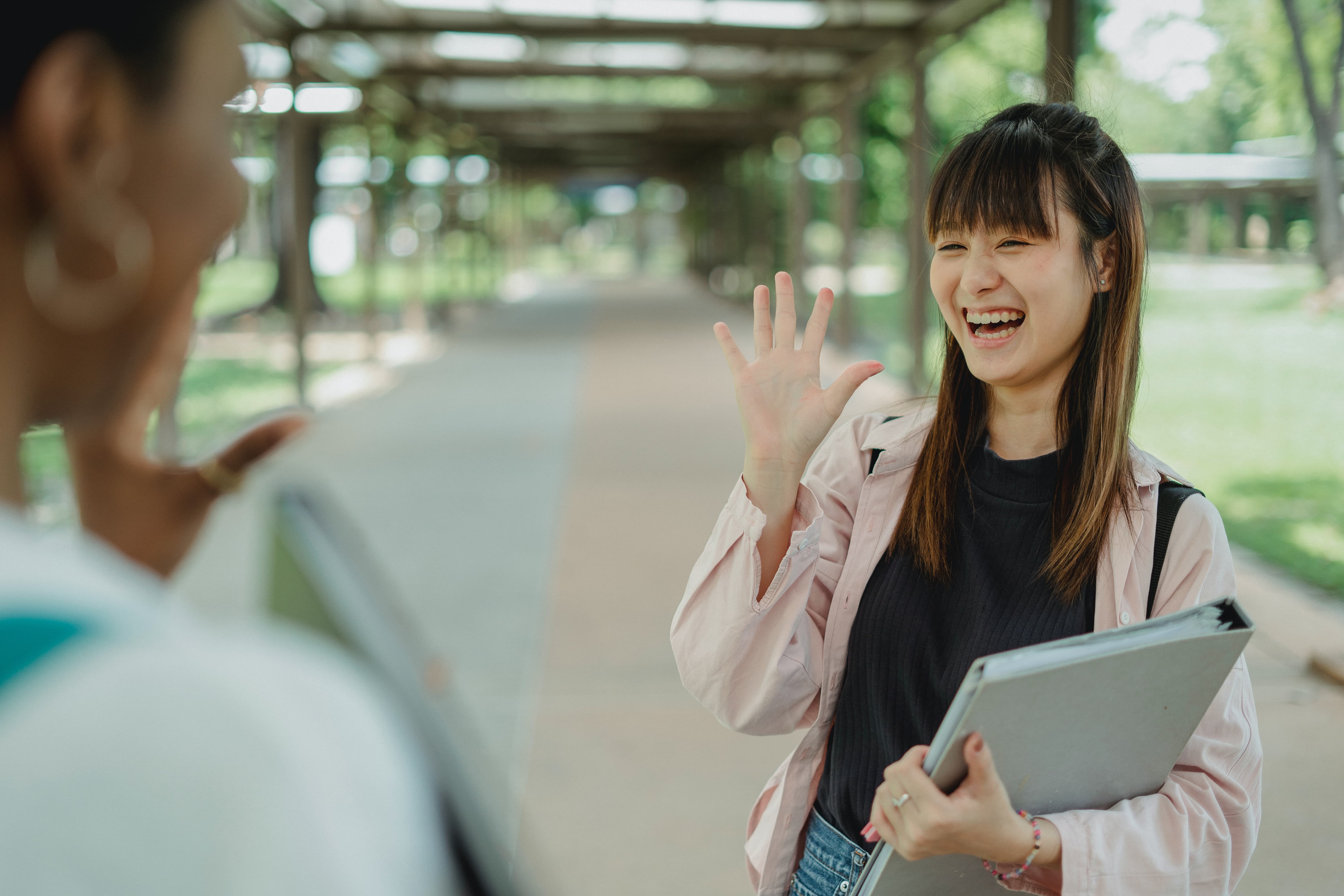 A woman saying hello to another woman 