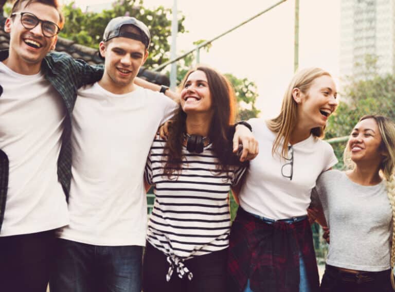 group of friends with arms resting on each other's shoulders