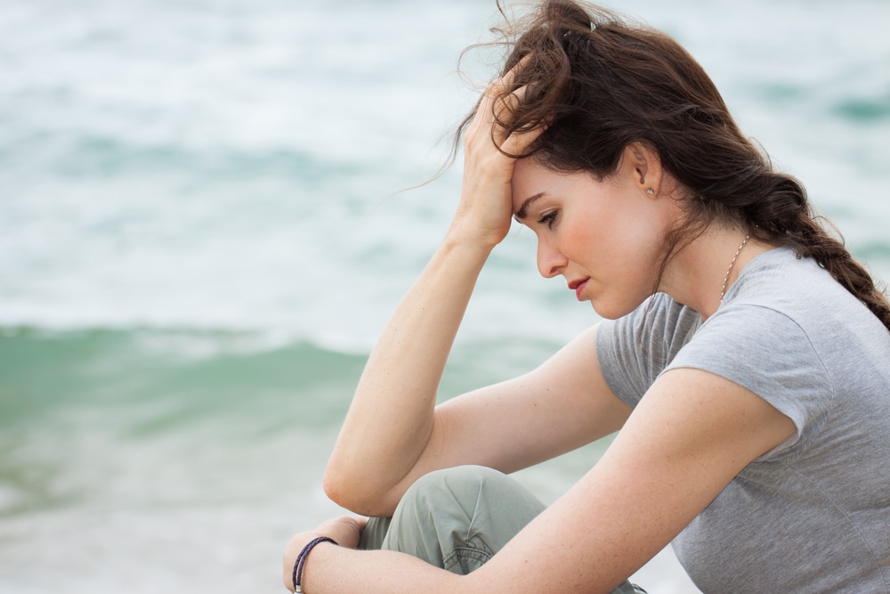 woman looking troubled at the beach