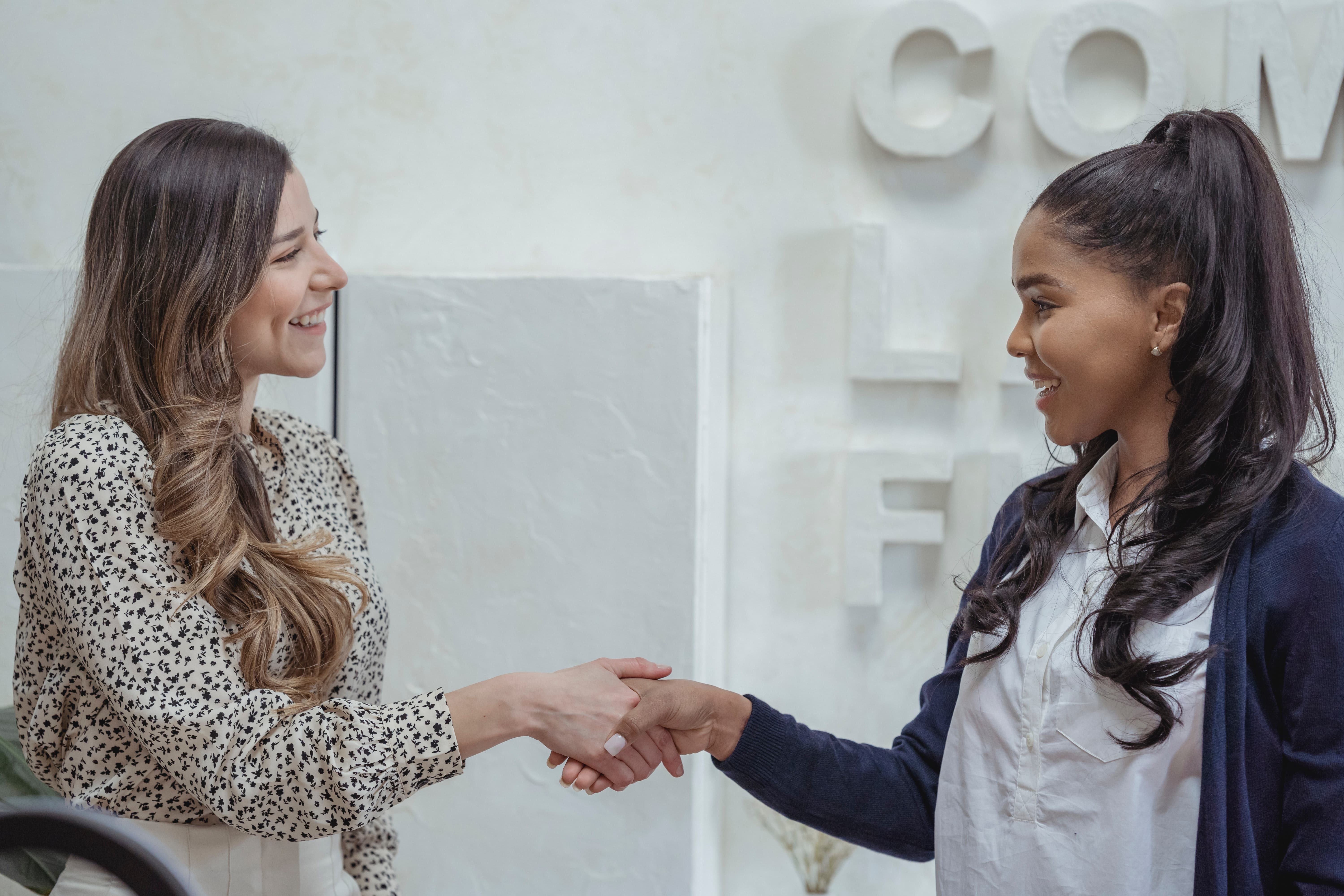 two-women-shaking-hands-in-office