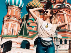 young woman in front of Saint Basils Cathedral in Moscow Russia