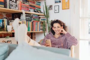 young woman listening to music on phone and smiling