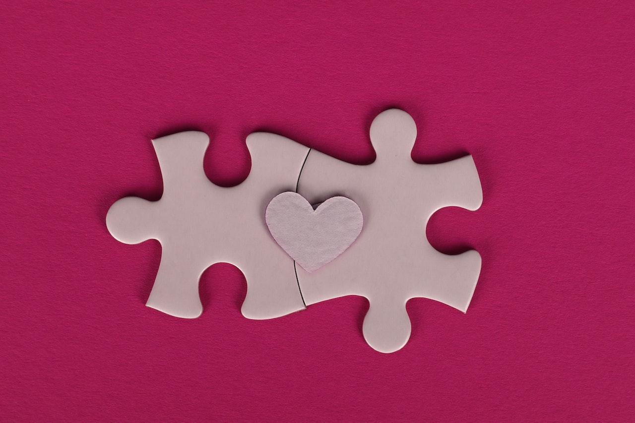 Puzzle pieces with a heart in the middle