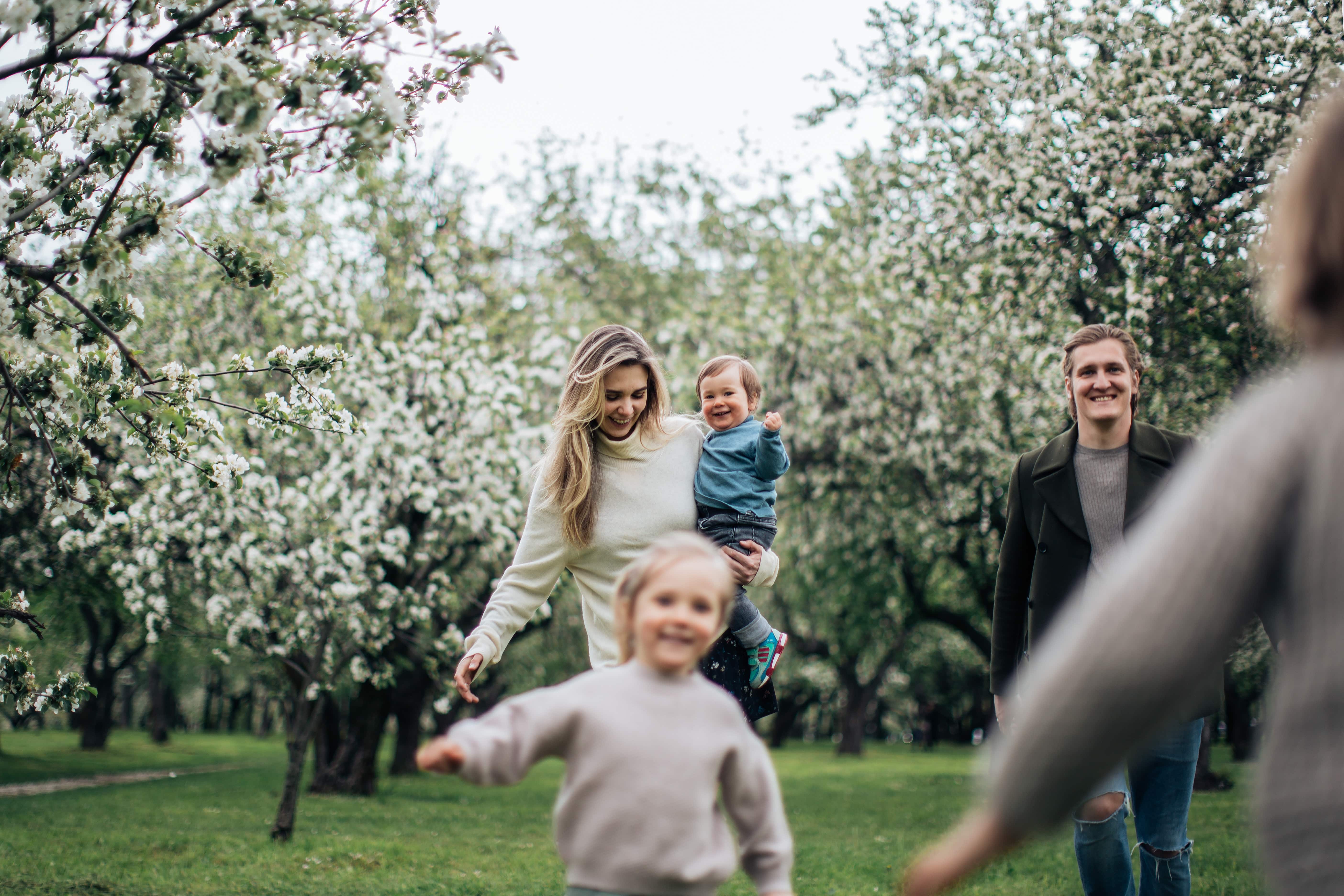 happy-husband-and-wife-at-the-park-with-their-three-children