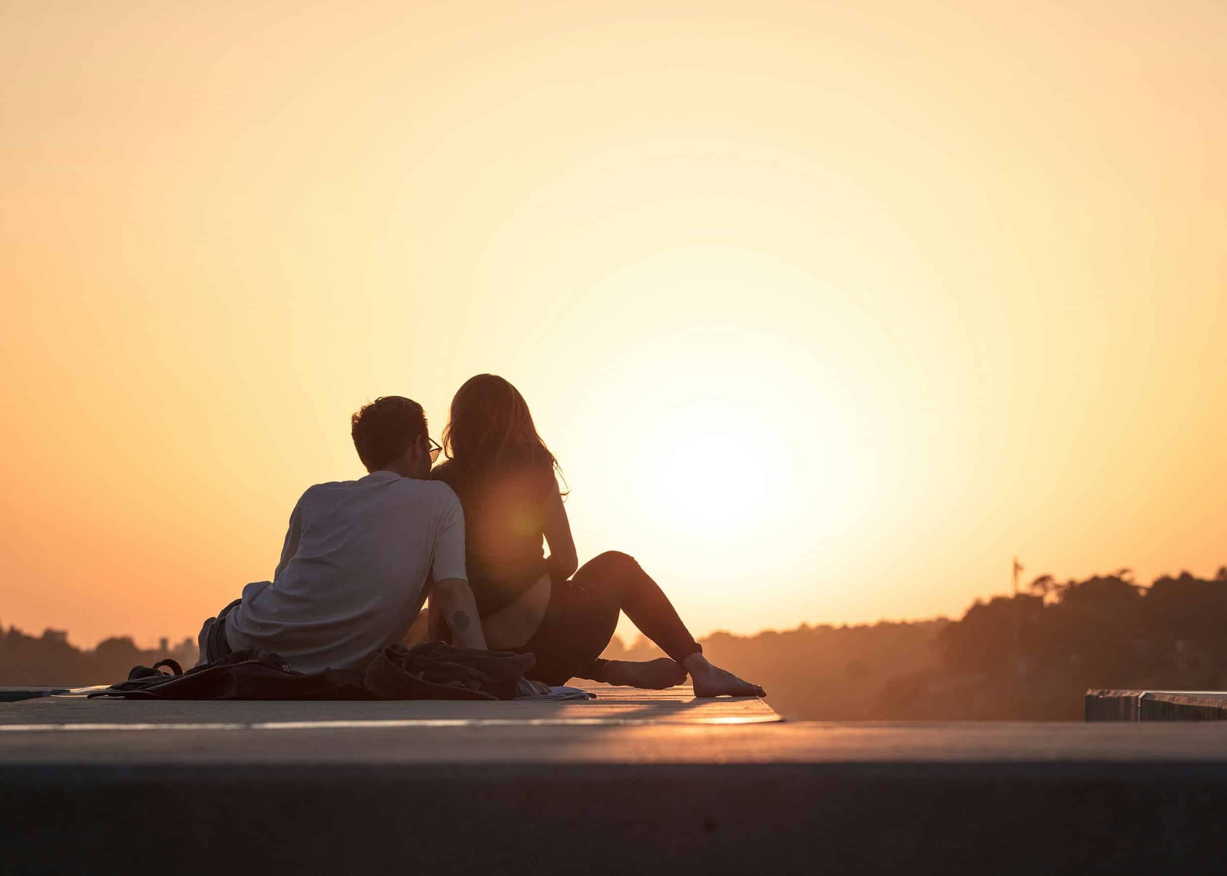 A couple in love watches the sunset