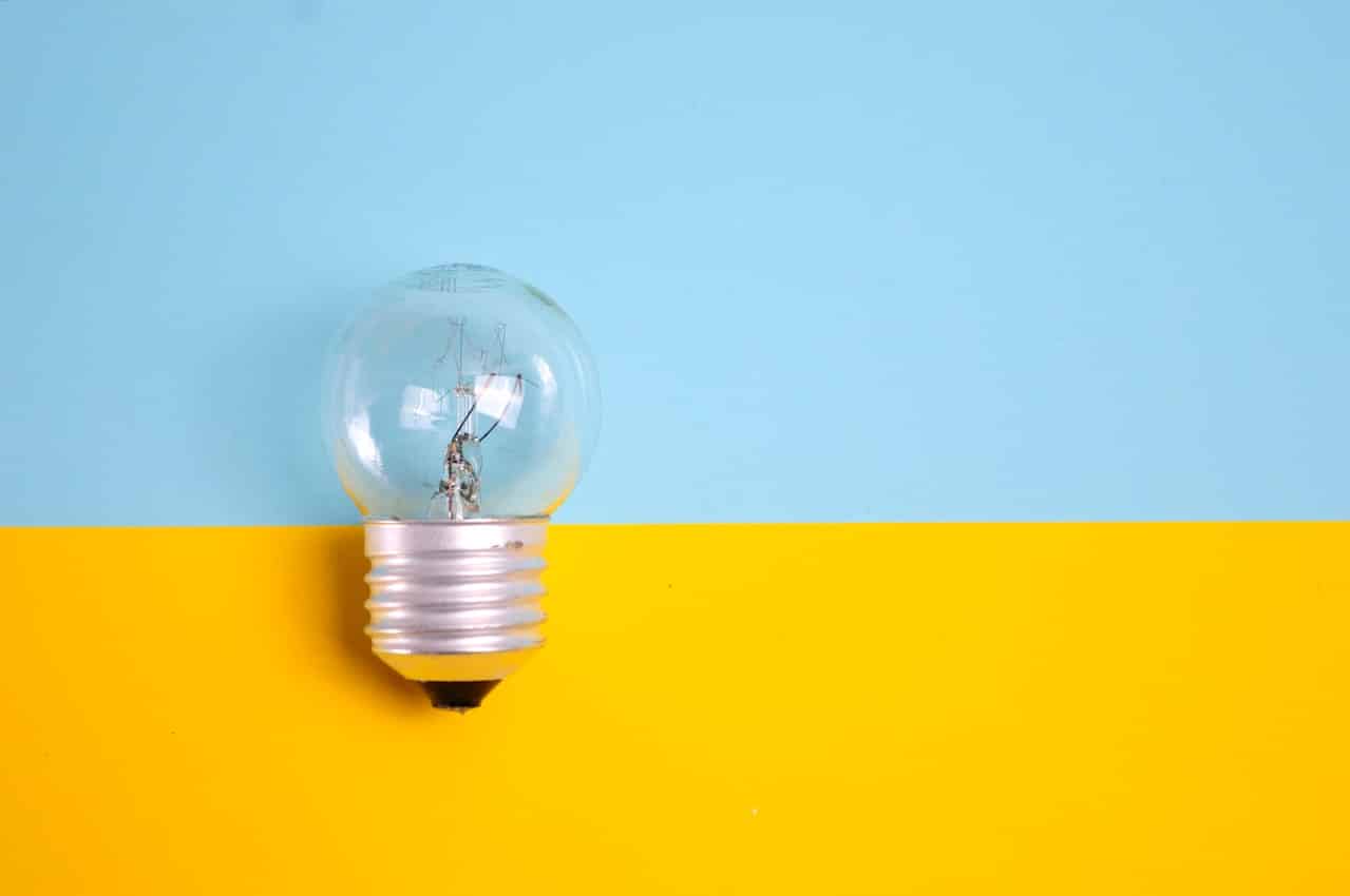 A bulb over a blue and yellowe blackground