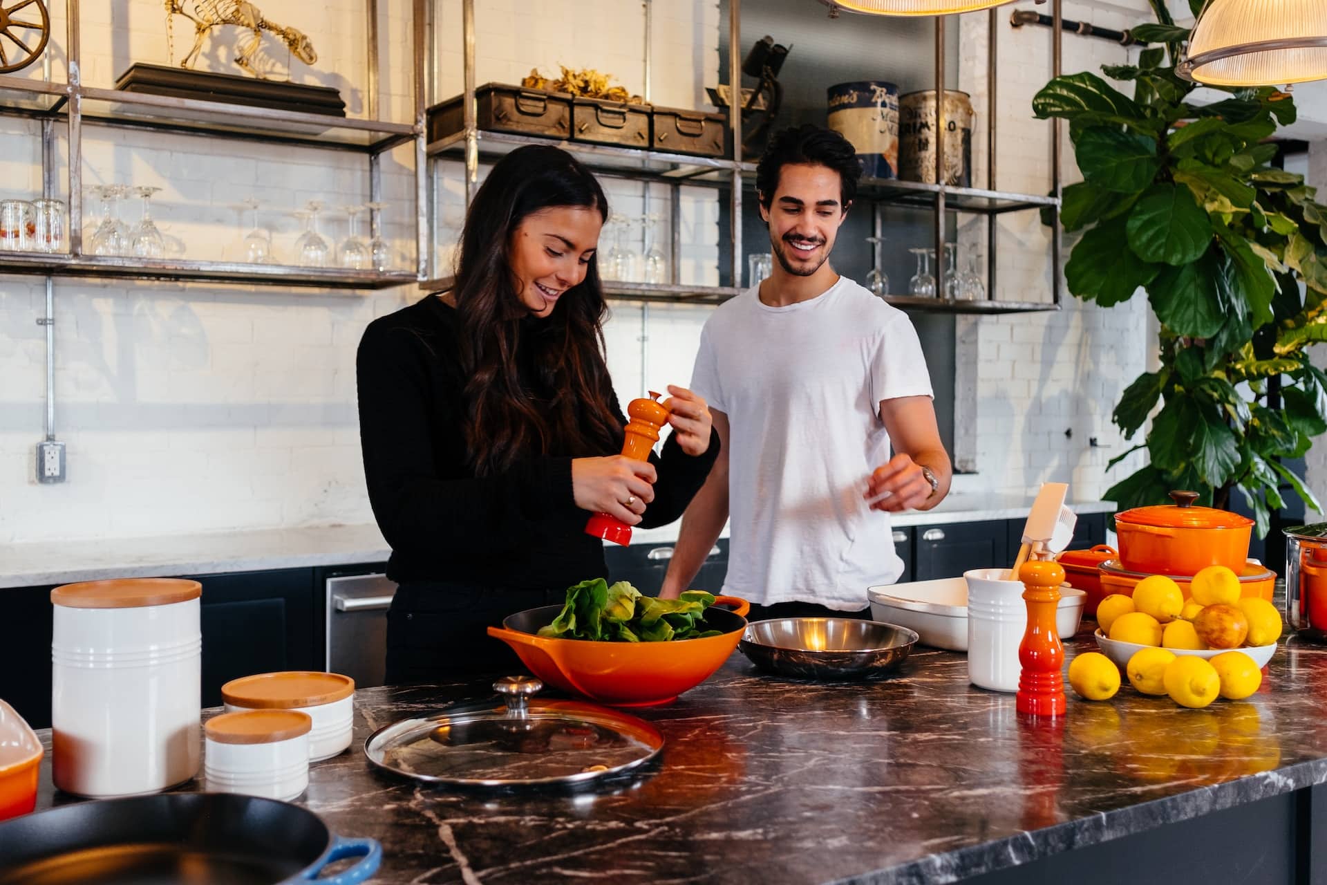 man and woman cooking together