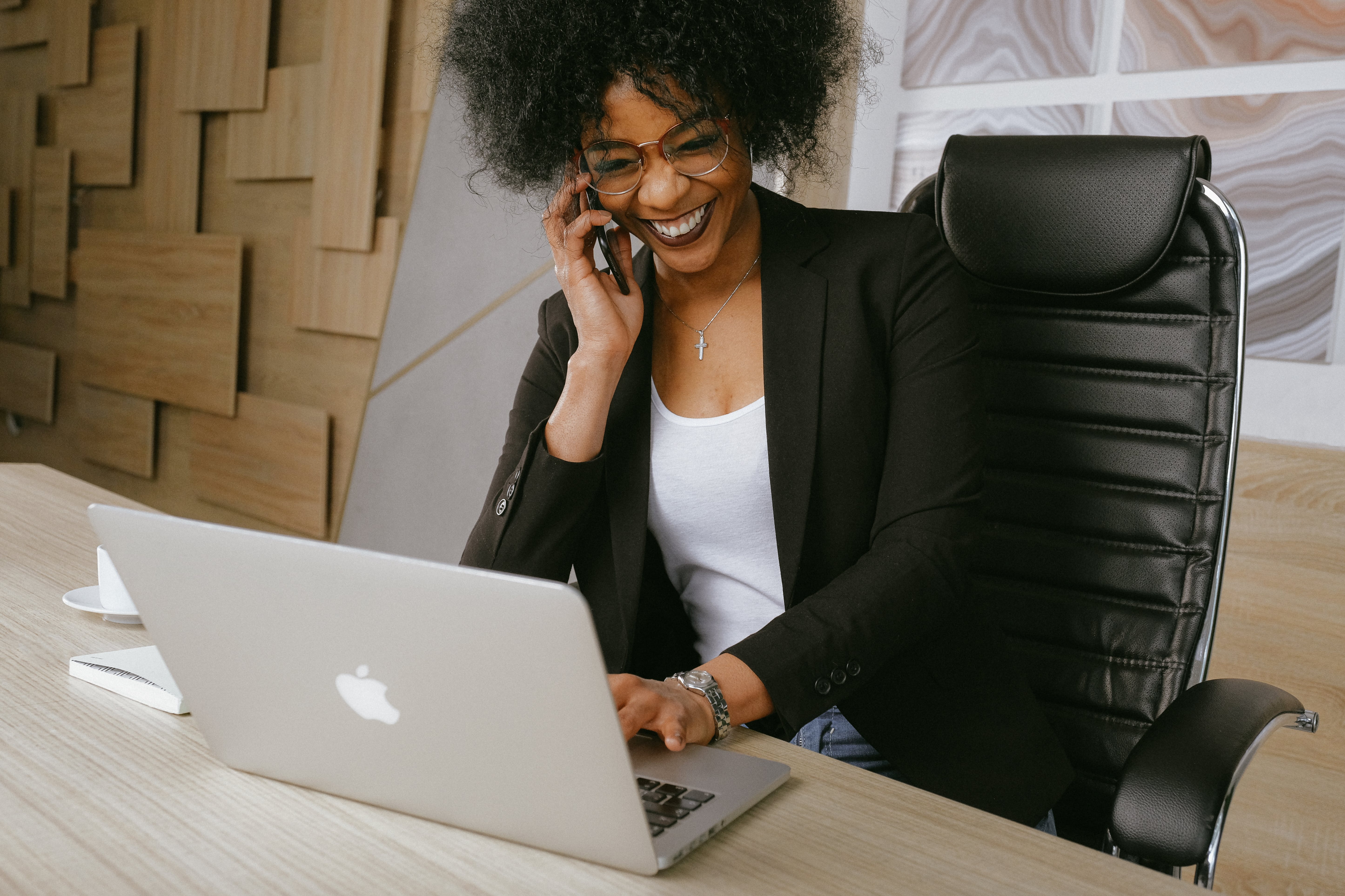 A woman talks on the phone in her office