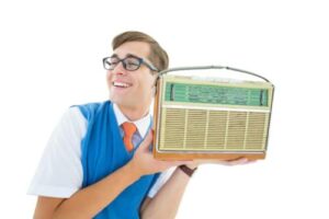 Guy with glasses holding a radio