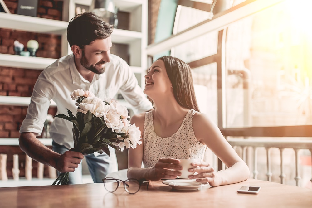 Man-giving-bouquet-of-flowers-to-woman