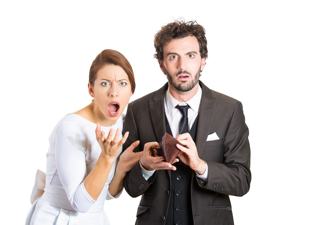 a couple holding an empty wallet