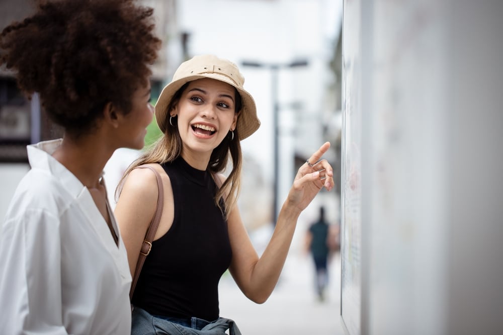 girl giving directions to tourist