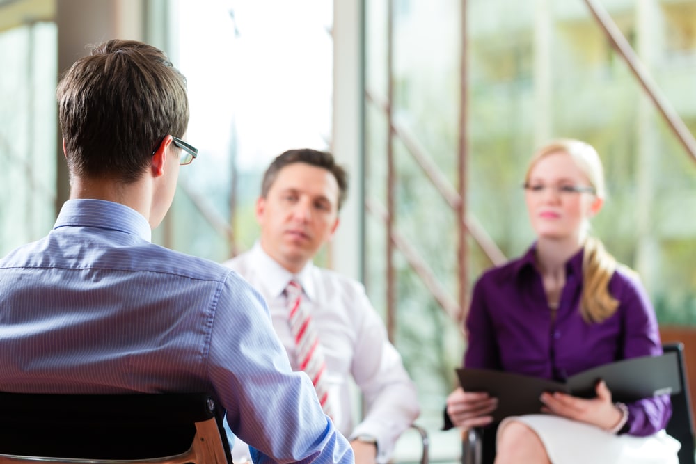 man and woman interviewing a man