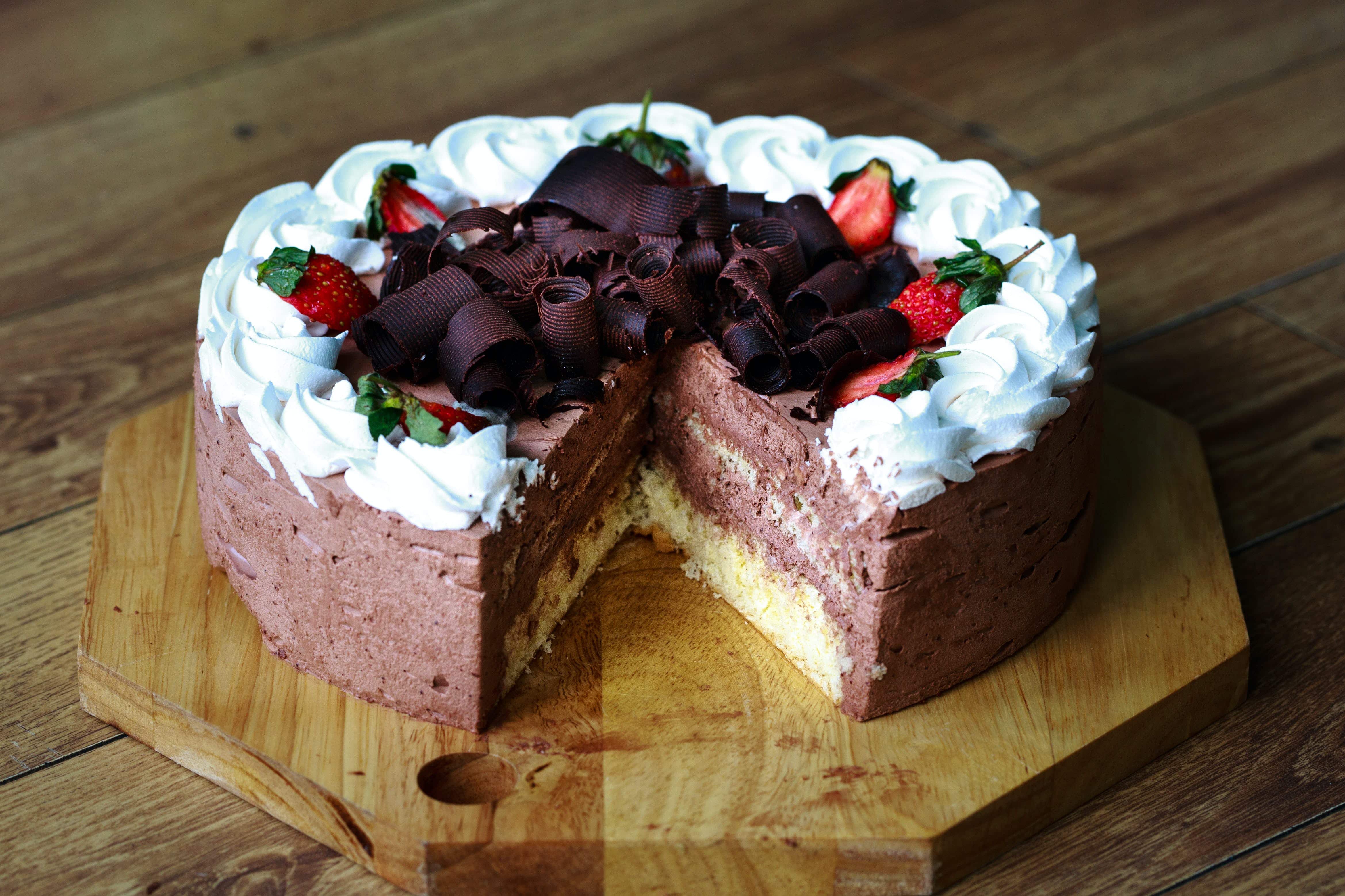 A decorated cake with one slice taken out of it