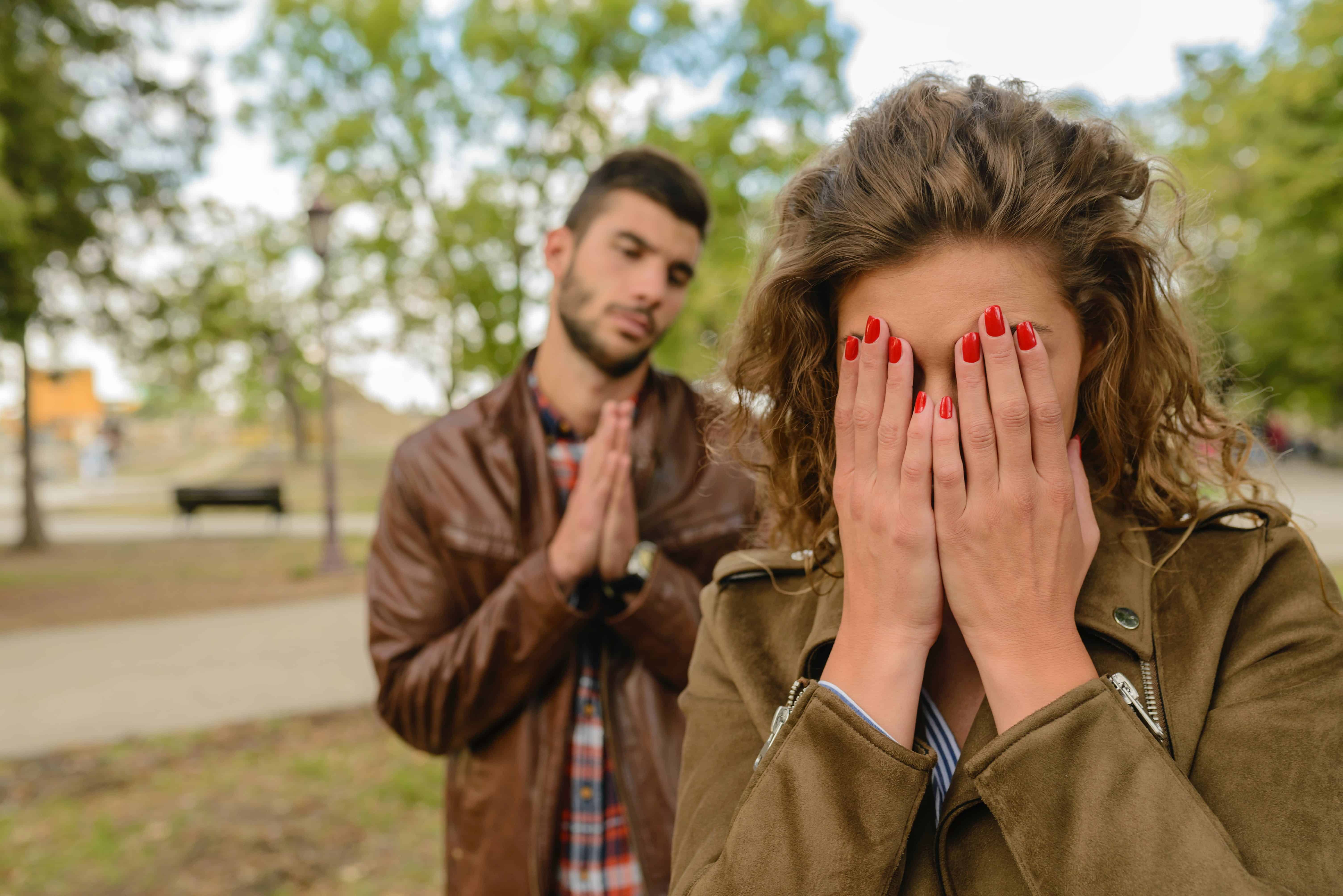 A couple has an argument in a park