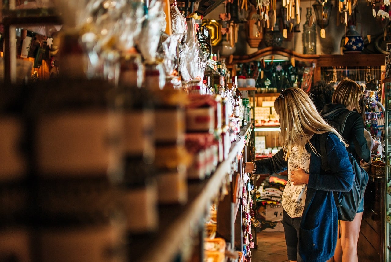 a woman looking at items on a shop shelf