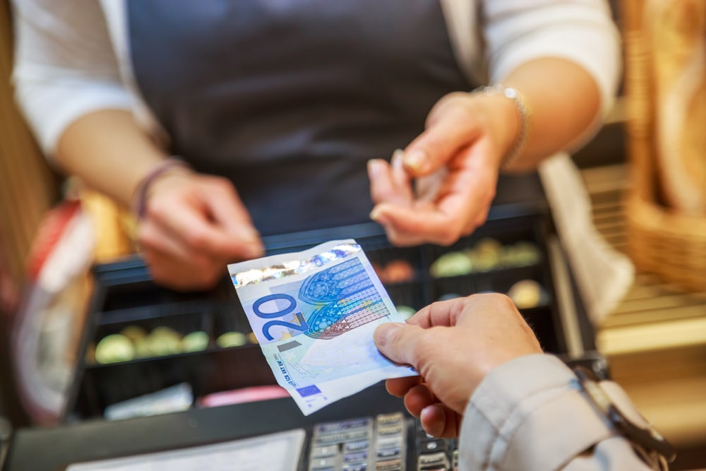 person-giving-euros-to-cashier