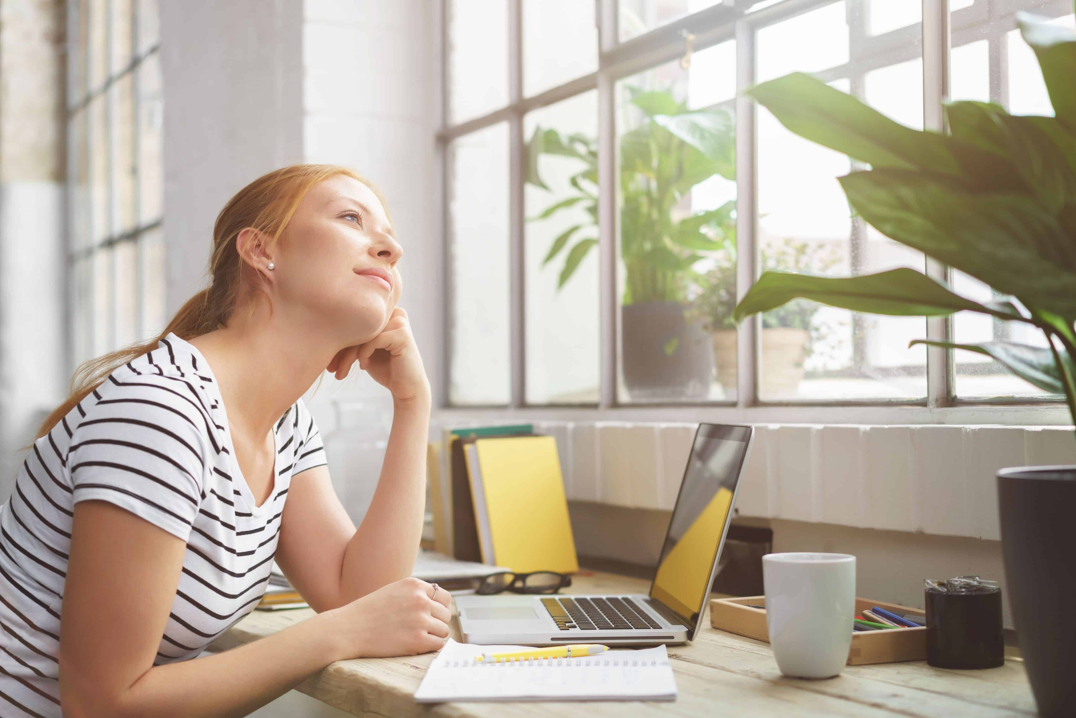 Girl thinking while working at a desk