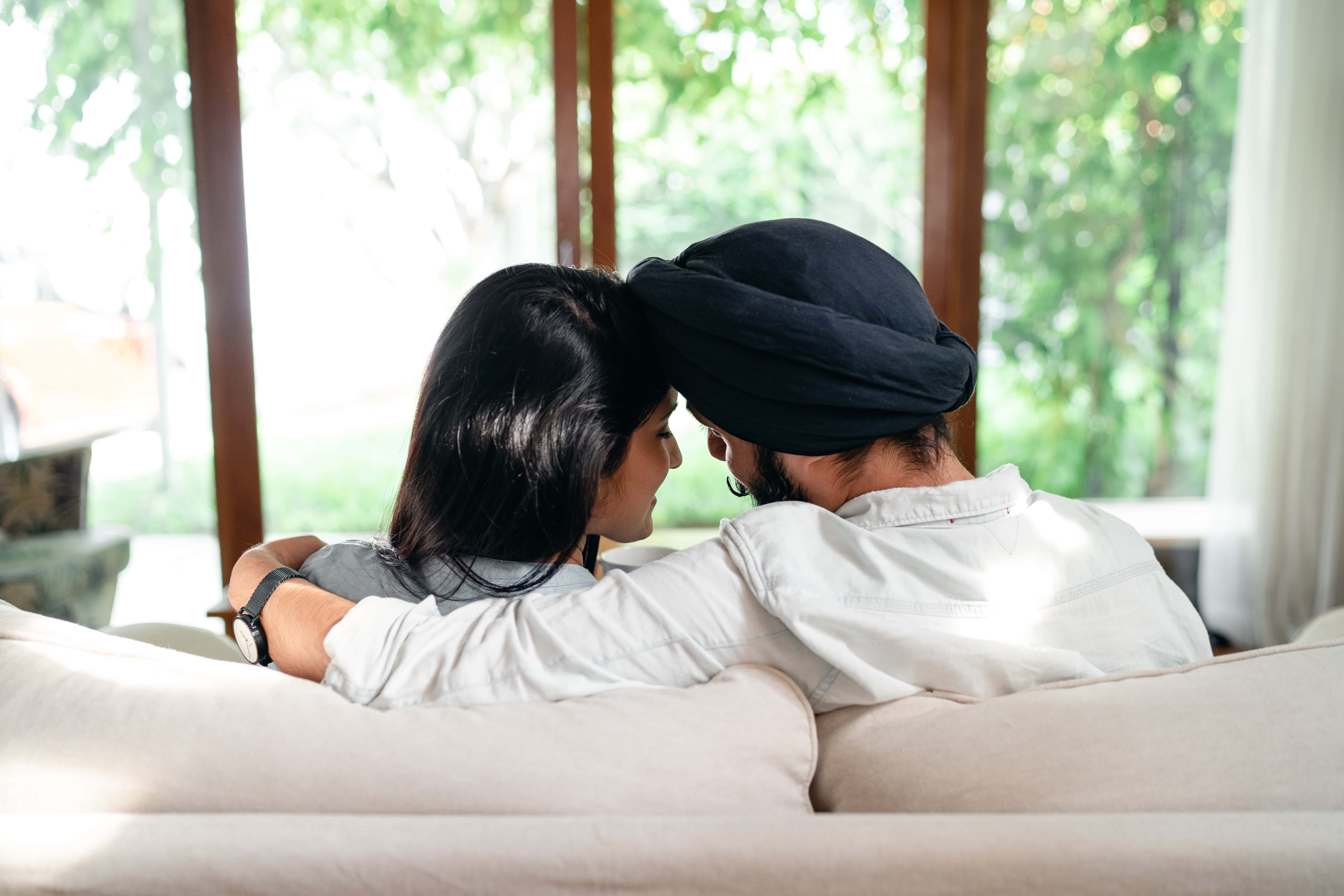 A couple sitting on a sofa