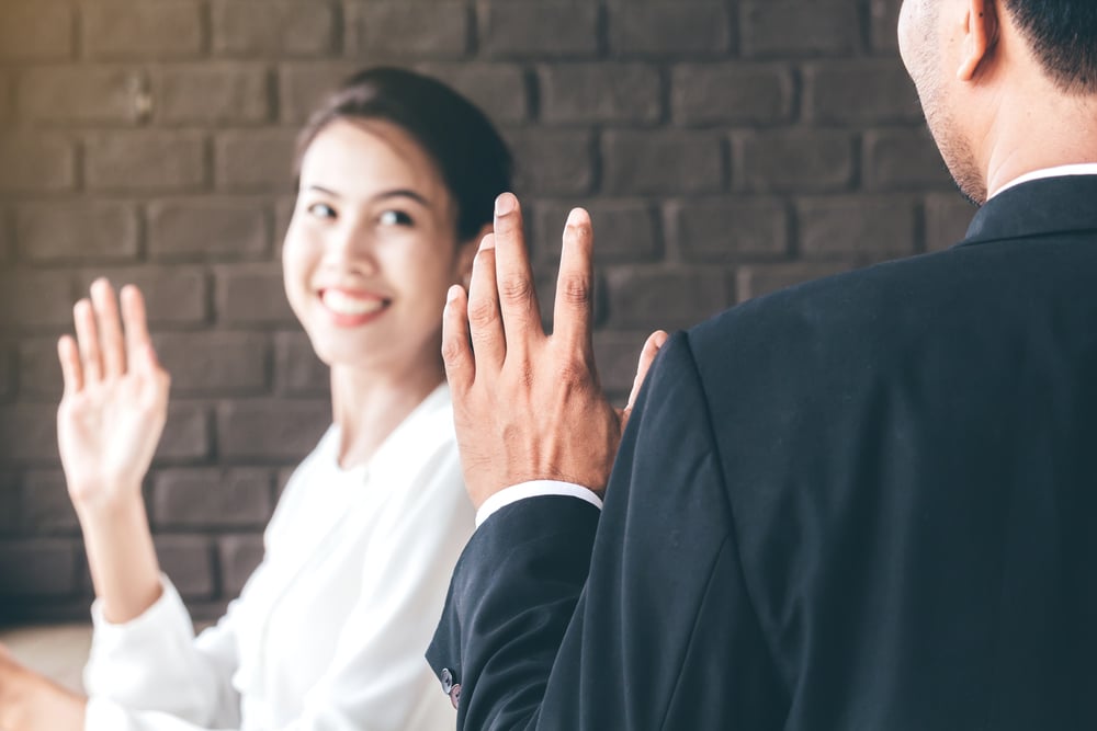 man-and-woman-waving-to-each-other-2