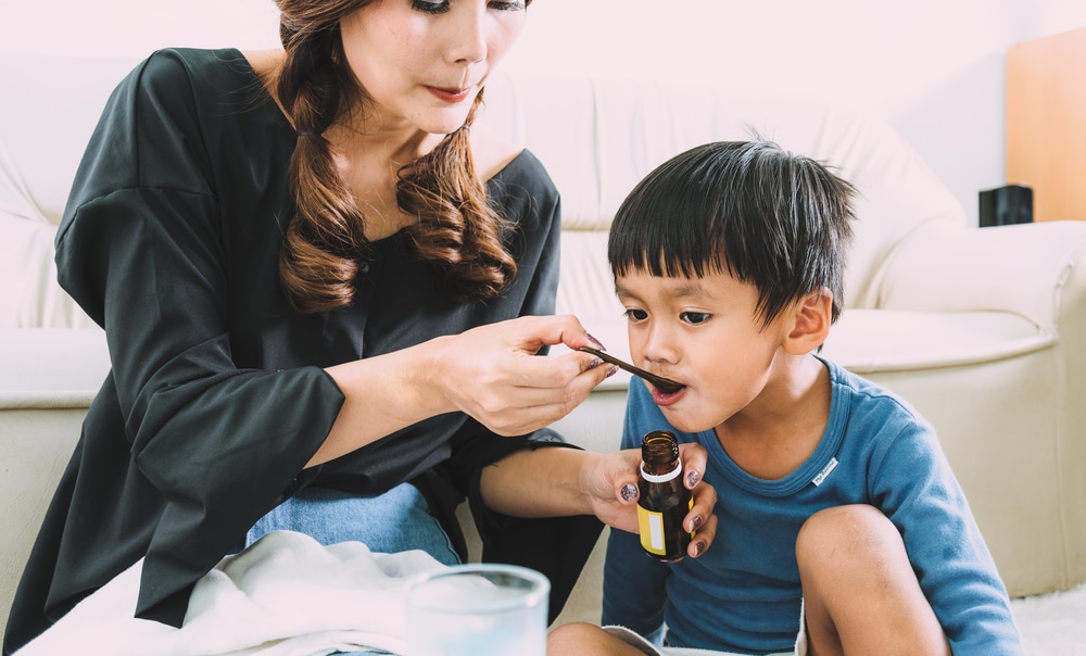 mother-giving-child-medicine