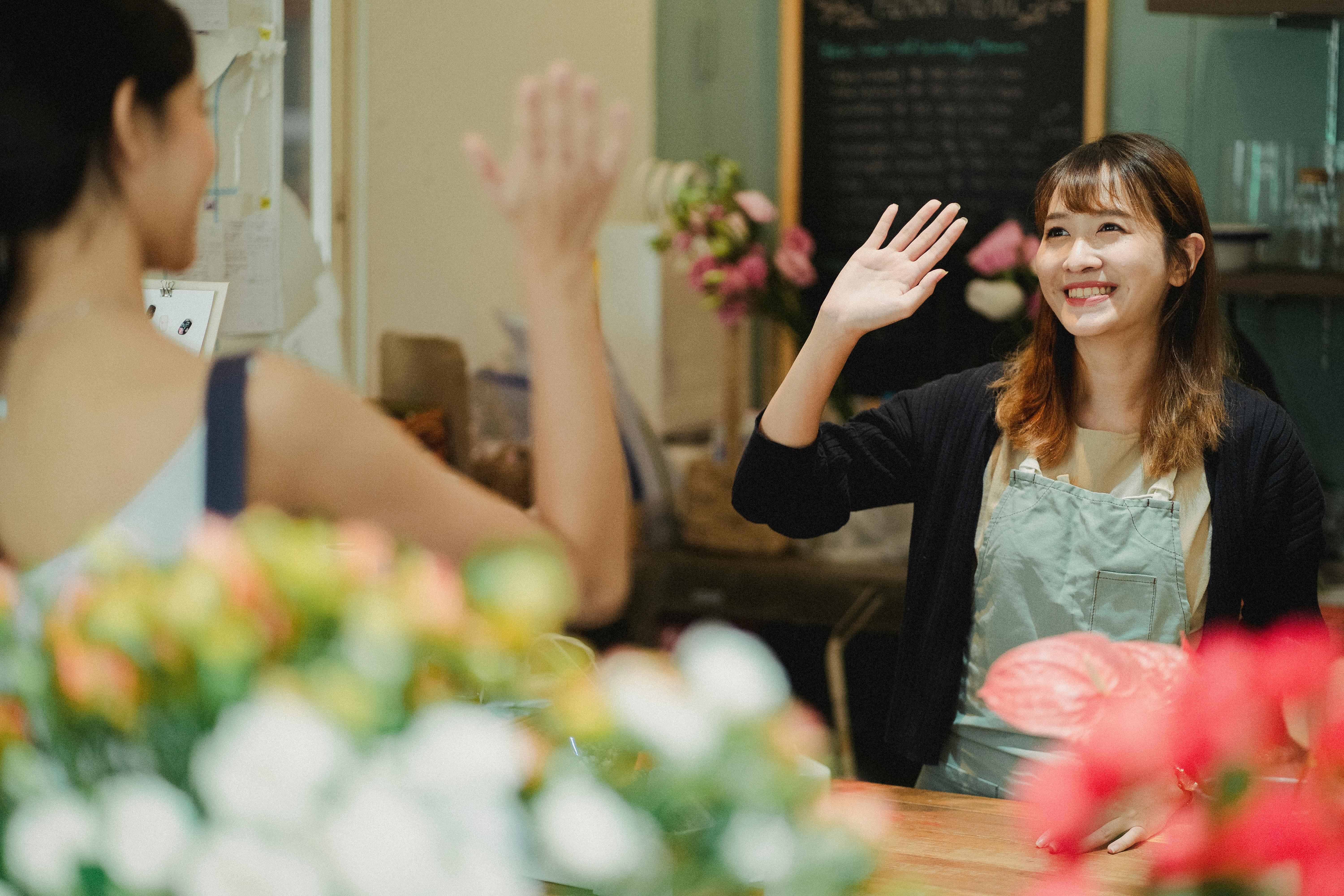 A woman waving goodbye to her friend