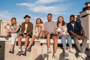 diverse group of friends sitting on a ledge