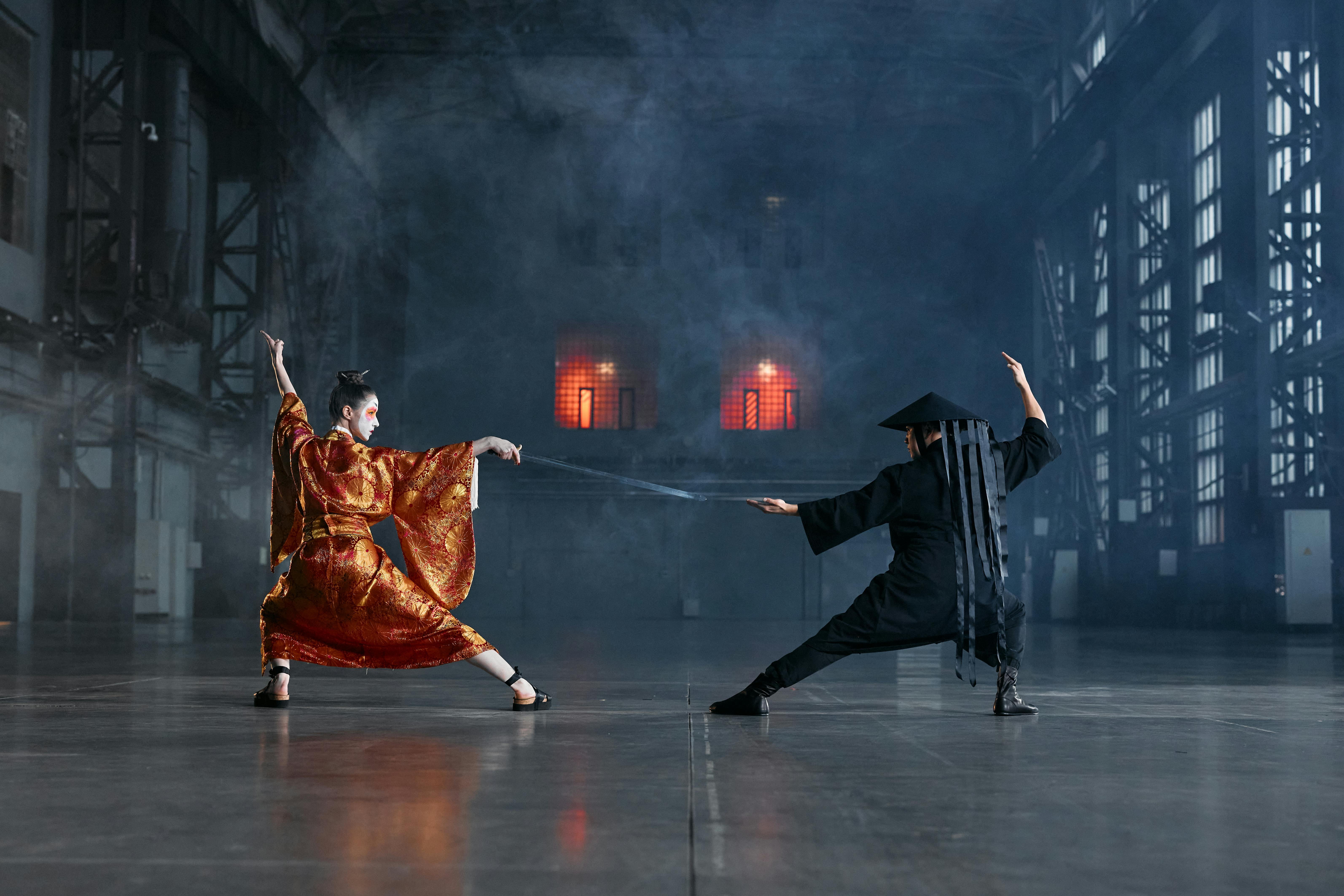 Two men practicing a martial art in traditional Japanese dress