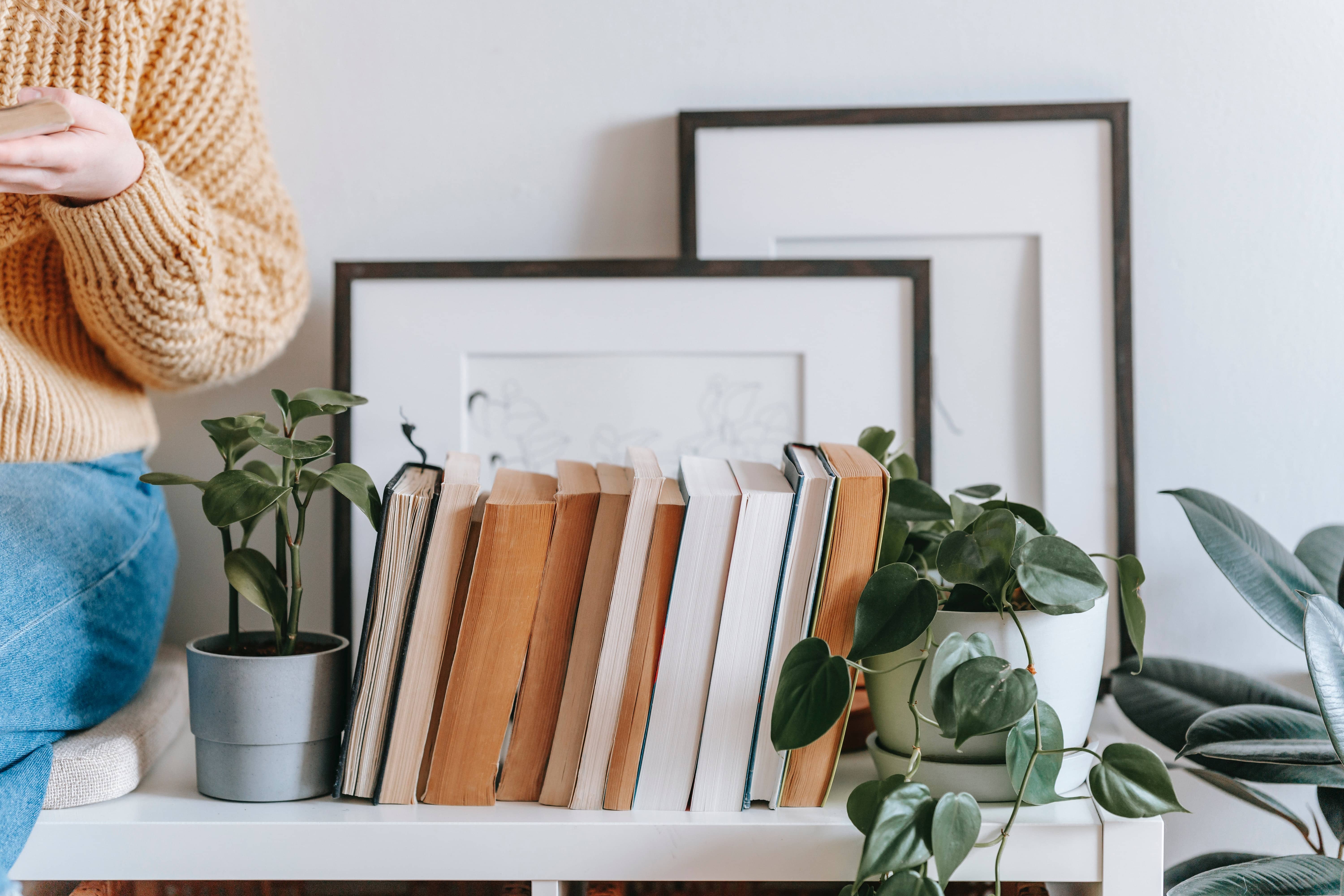 Books next to plants on a shelf