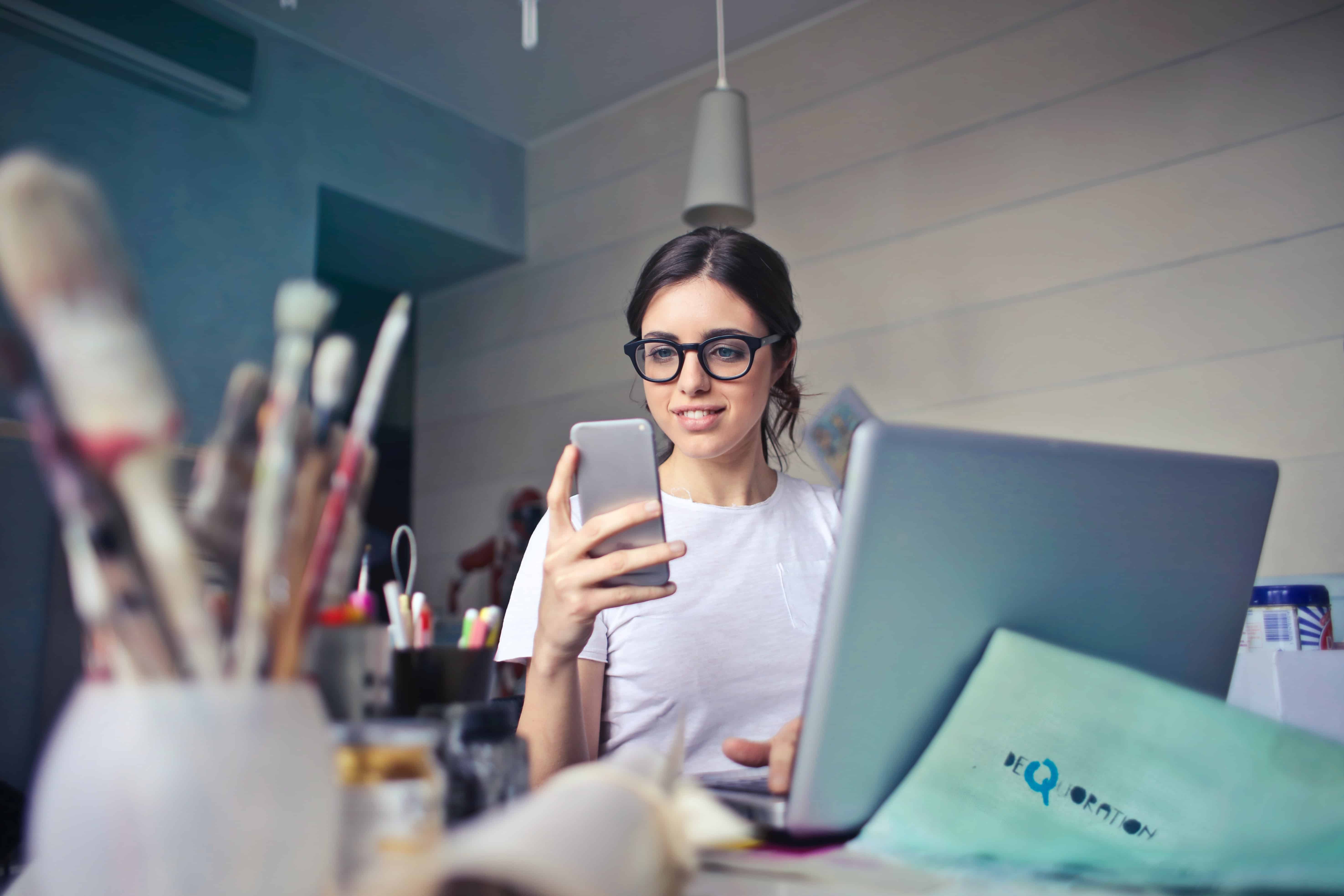 young-woman-on-phone-and-laptop