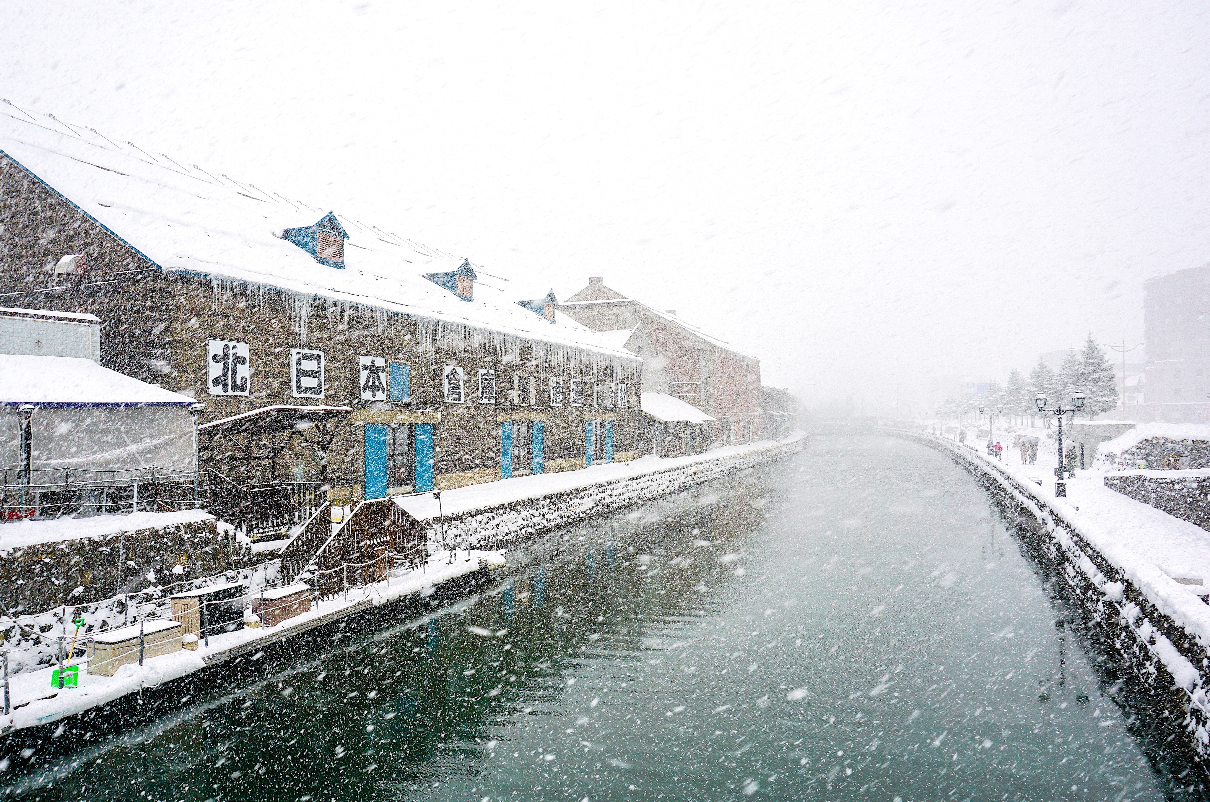 Snow falling over the river in Hokkaido Japan