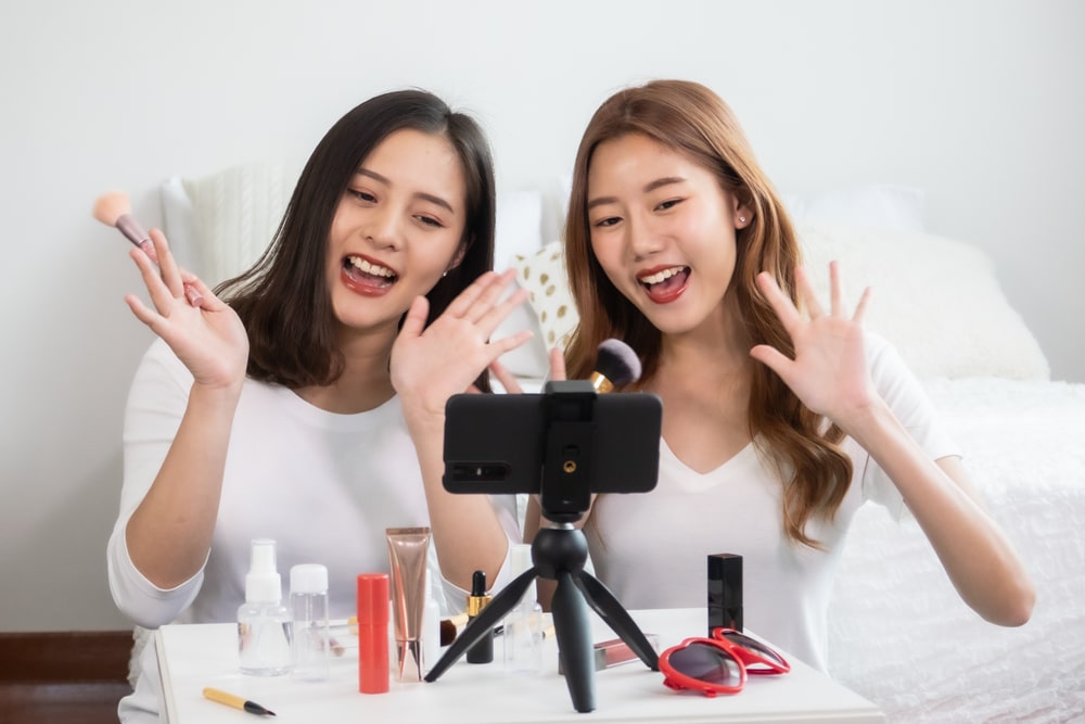 two young girls shooting a video